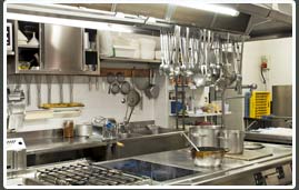 professional large kitchen with pots and pans